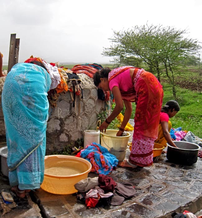Women bent over washing 