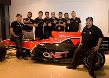 QNet Management team pose with replica car Formula1