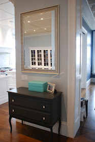 Ikea cabinet and mirror function as a morning launching pad for a busy family of 5.