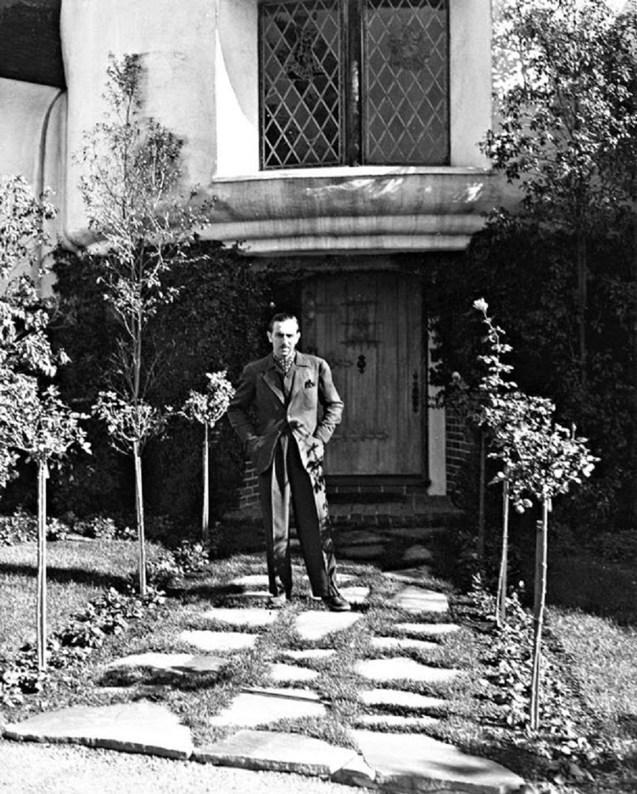 Walt Disney at the front of his home.