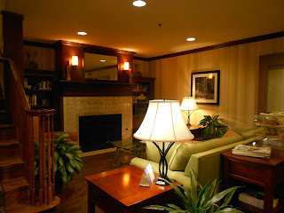 a living room with a fireplace and a lamp