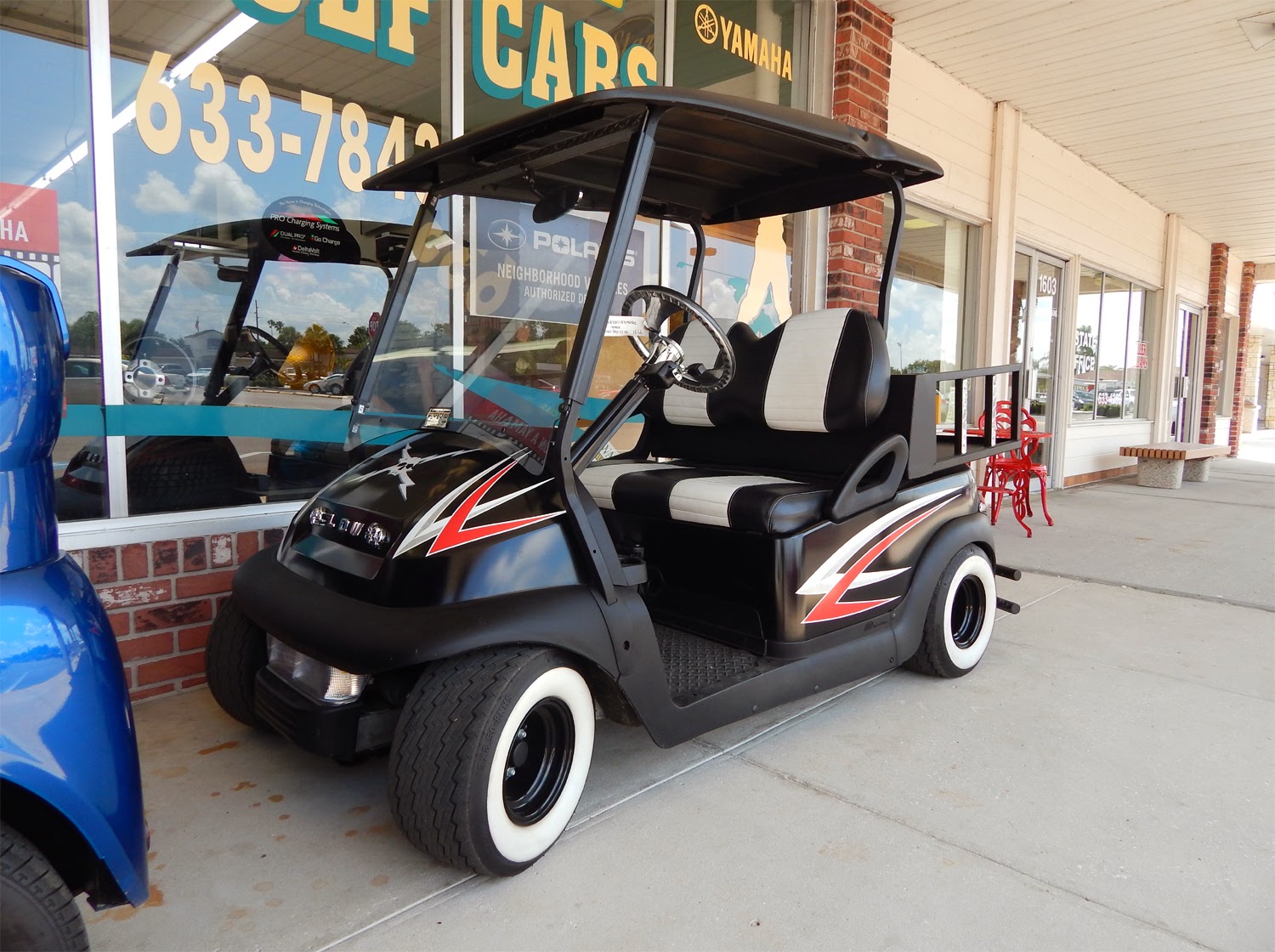 Low Rider scull and cross-bolt Club Car golf cart in Sun City Center Plaza