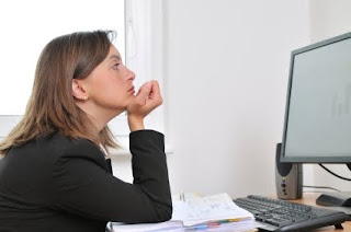 Go on. Take few moments off. You deserve it! (Photo: iStock/Martinan) bored woman at work