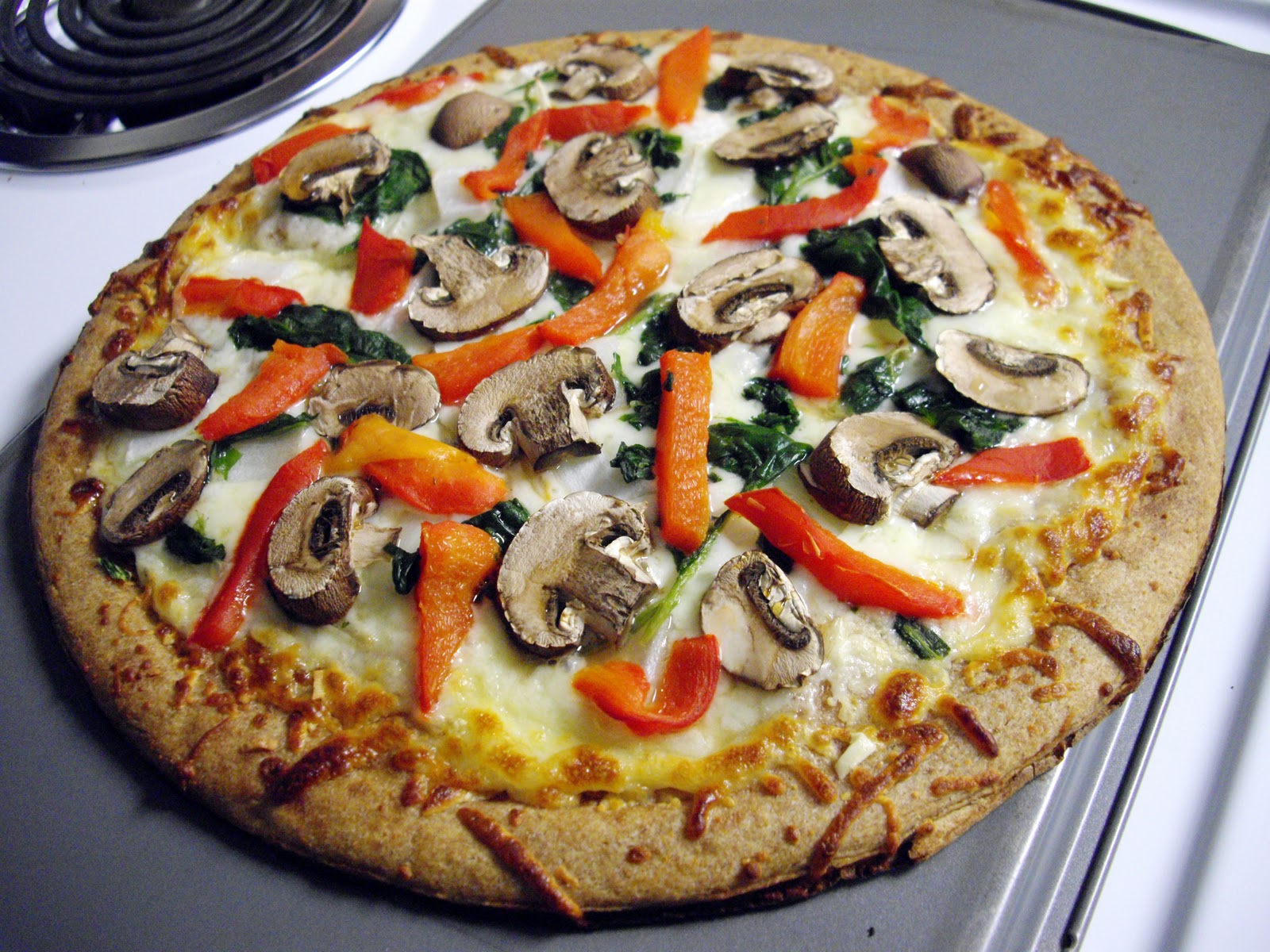 White Pizza with Roasted Red Peppers, Mushrooms, Spinach & Onions cooking ala mel