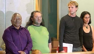 Image of the four defendants in court.