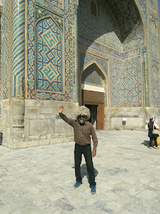 Seafarer/Blogger/Traveller Rudolph.a.Furtado in Ulugh Beg Madrasah courtyard  wearing a Uzbek cap.