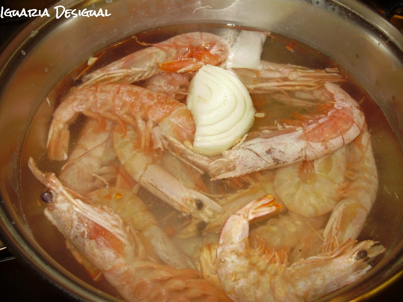 A cozer o camarão Camarão frito em azeite com alho e coentros