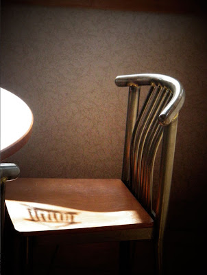 chair with greek temple shadow on seat