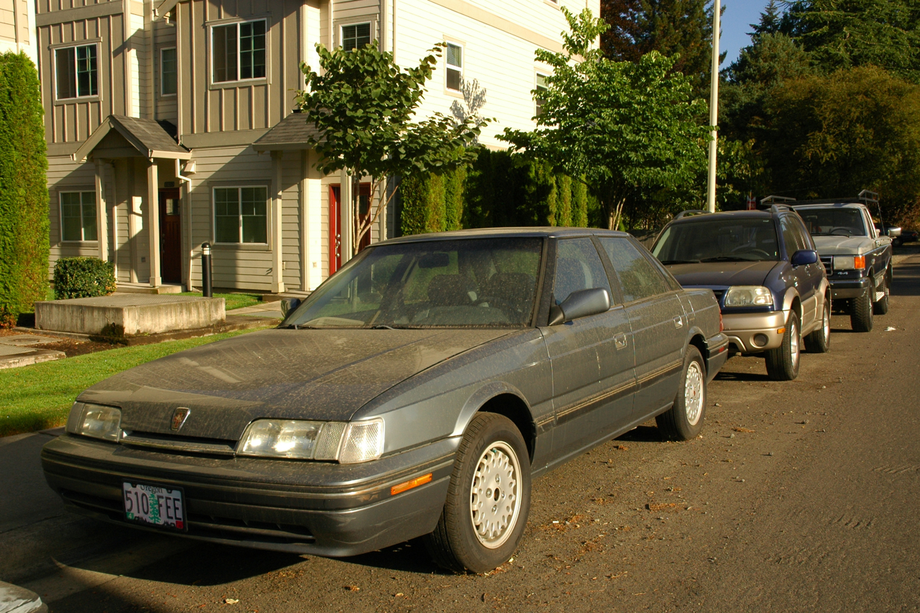 OLD PARKED CARS. 1990 Sterling 827 SL.