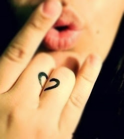 a heart tattoo with half inked on one finger and half one the other