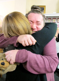 The winner of the Fairy Meadow Miniatures shop VIP opening raffle hugging the owner.