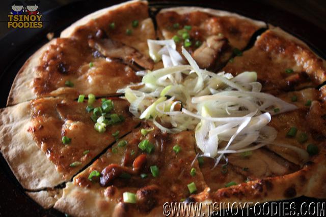 pizza topped with chicken teriyaki
