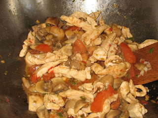meat, tomatoes, mushrooms garlic and chilli all go into the wok with some olive oil 
