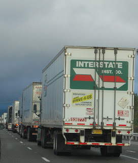 Photo of Line of Semi Trucks on the Freeway