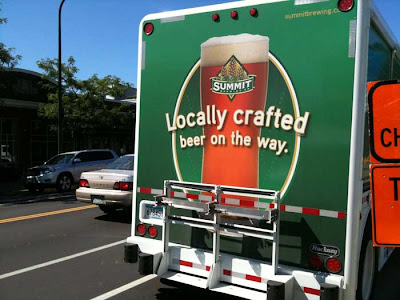 Back of truck with glass of beer and words Locally Crafted Beer on the Way