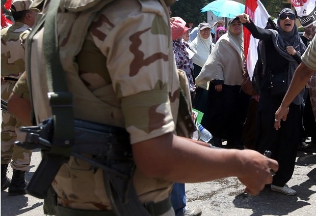 Photo: AP A supporter of ousted Egyptian President Mohammed Morsi, right, shouts slogans at Egyptian army soldiers during a demonstration in front of the National Council for Human Right building in Cairo, Egypt, Sunday, July 21, 2013. Clashes between protesters and security forces have erupted into violence several times since Morsi's ouster, killing more than 60 people. The most recent incident occurred Friday night in the Nile Delta city of Mansoura when unidentified assailants opened fire at a Brotherhood-led march, sparking a melee that killed three female protesters, authorities said (think IN pictures @1WORLDCommunity)