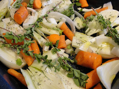 carrots, onion, fennel and herbs in a roasting pan for roast chicken