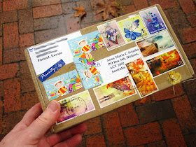 Small package from Finland, covered in colourful postage stamps
