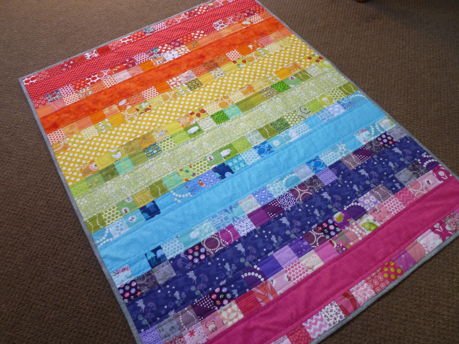 Stitch and Pieces Poppy's Rainbow Quilt A finished quilt