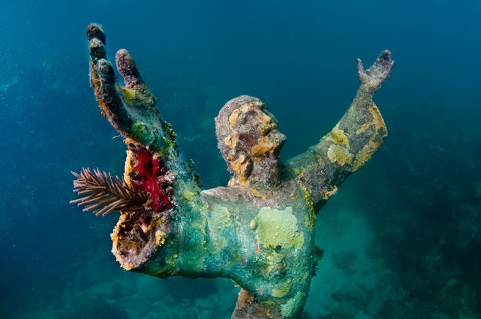 Christ of the Abyss is a submerged bronze statue of Jesus, of which the original is located in the Mediterranean Sea off San Fruttuoso between Camogli and Portofino on the Italian Riviera. It was placed in the water on 22 August 1954 at approximately 17 metres depth, and stands c. 2.5 metres tall. Various other casts of the statue are located in other places worldwide, both underwater and in churches and museums. The sculpture was created by Guido Galletti after an idea of Italian diver Duilio Marcante. The statue was placed near the spot where Dario Gonzatti, the first Italian to use SCUBA gear, died in 1947. It depicts Christ offering a blessing of peace, with his head and hands raised skyward.