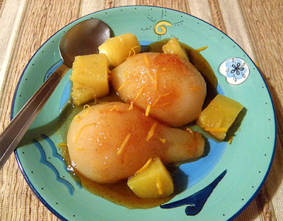 Plate of one half two kinds of pears with sauce and pineapple