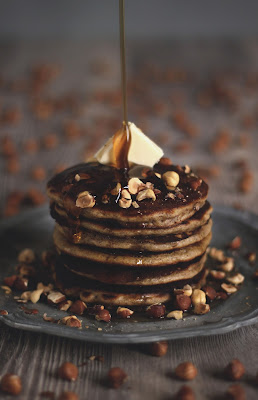 An elegant and classy stack of pancakes with hazelnuts, butter and maple syrup... An energy and brain booster recipe brought to you by the German foodblog Pancake Stories.