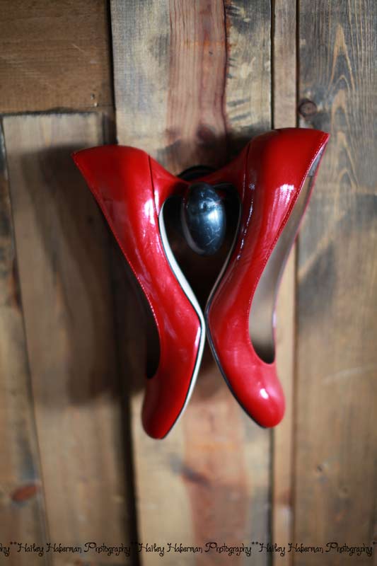 Fontaine Estates Wedding Photographer captures bride's shoes hanging on rustic door