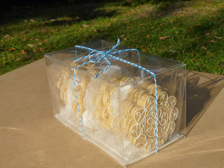 highly decorated lemon-rosemary tea biscuits in a crystal clear box