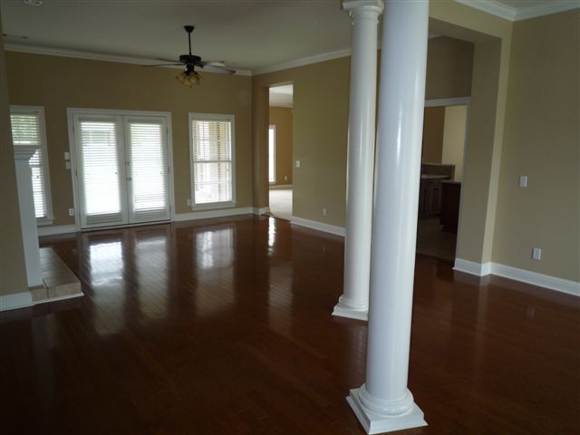 Great Room with Dining Room to right side; Kitchen & Family Rooms through doorways on back/right