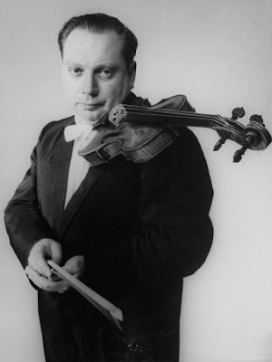 gjon-mili-portrait-of-violinist-isaac-stern-holding-his-violin.jpg