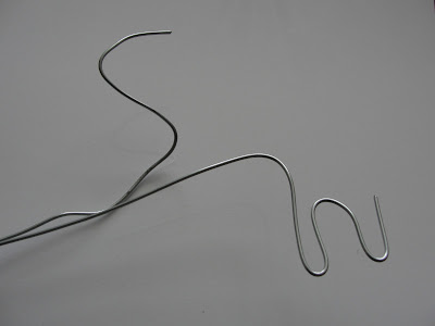letters S and W bent in wire