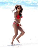 Mel B dancing at a beach in a bikini