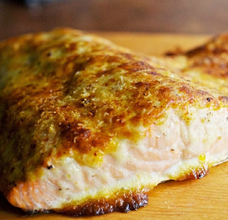 Coating the salmon with a mixture of mayonnaise and Parmesan cheese and