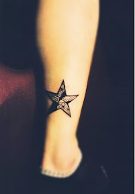 black star tattoo on the leg