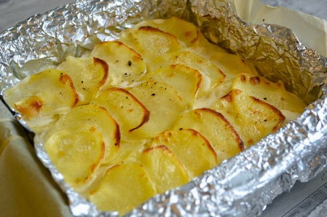 layered potatoes which are nearly cooked