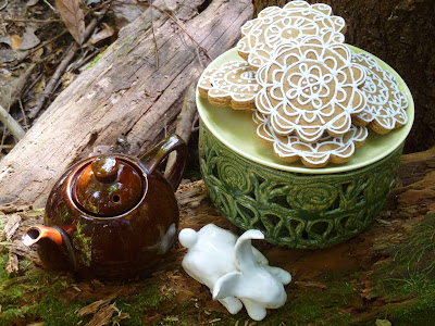 woodland teapot, ceramic bunny, decorated gingerbread cookies, moss on log
