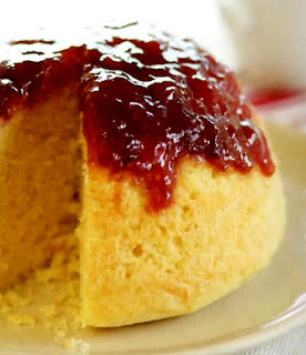 basic steamed white sponge pudding with a strawberry jam topping