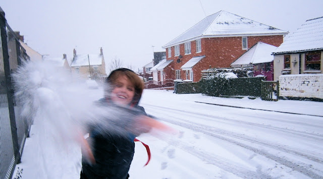 boy throwing snowball great photo