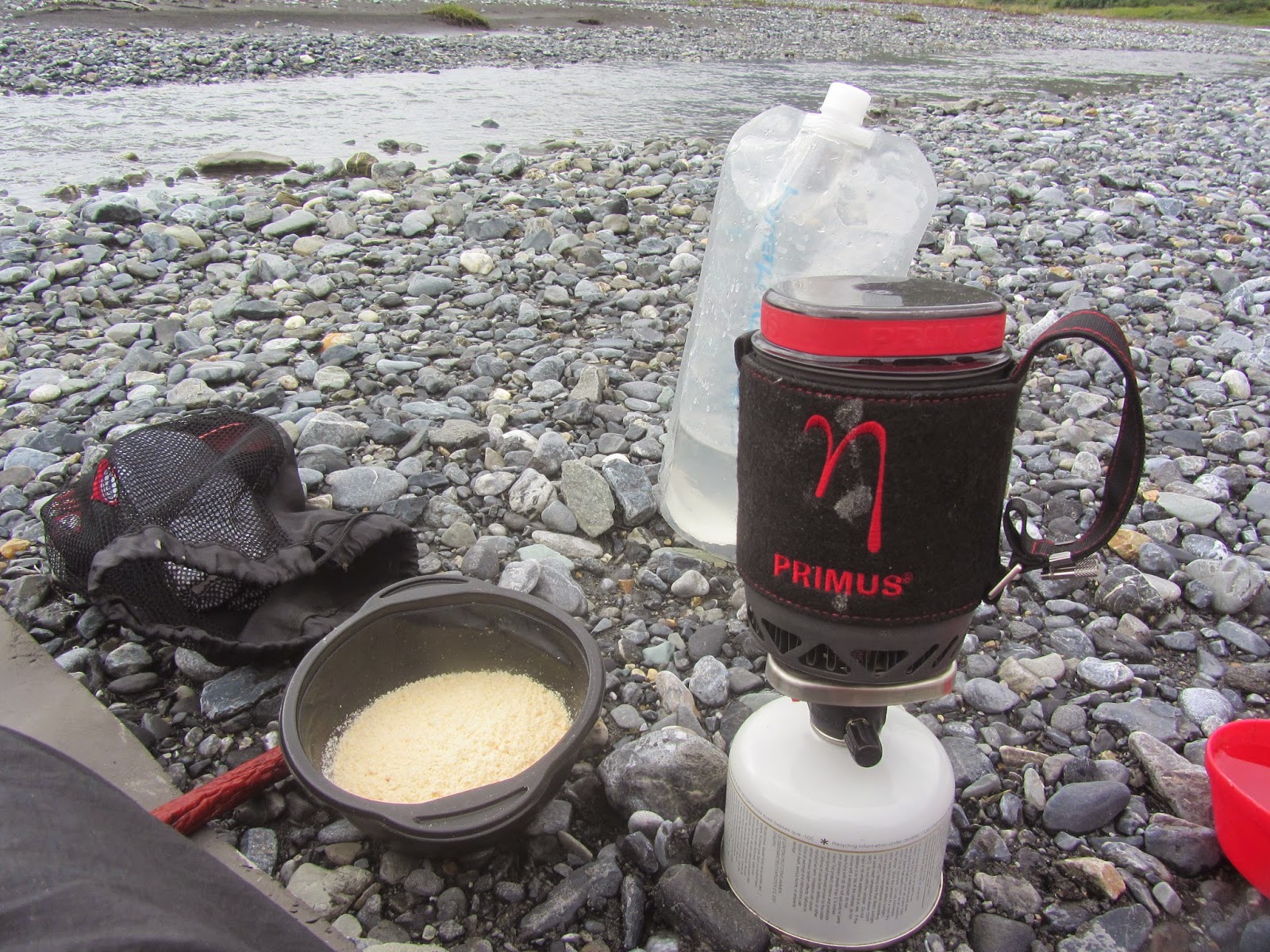 Brooks Range gear reflections on stove and footwear