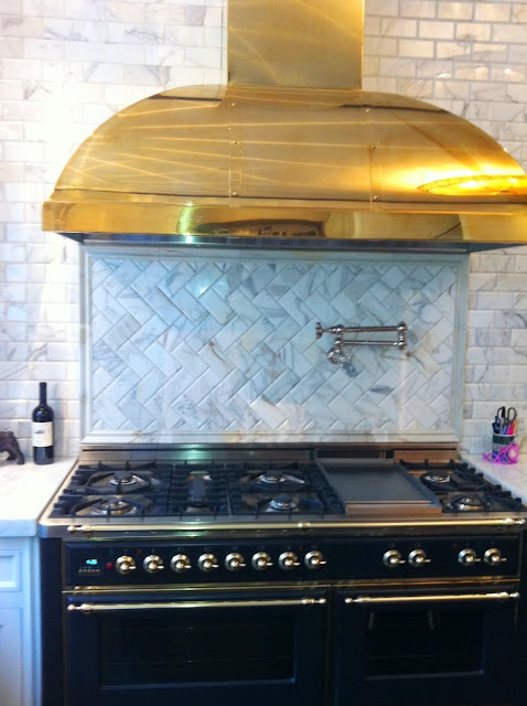 Kitchen with ILVE Majestic stove and custom brass hood to match the knobs and pulls