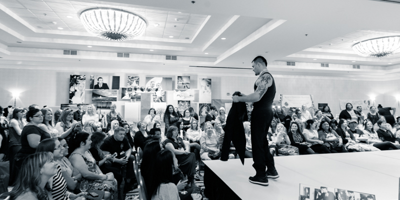 Groom taking shirt off Bakersfield Marriott Bridal Show