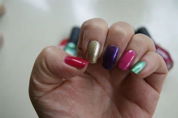 One Direction Nail Polishes Raspberry Rush, Popstar Purple, Everything Emerald, Gold & Gorgeous, Fuschia Frenzy Swatches