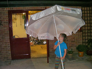 boy holding giant umbrella