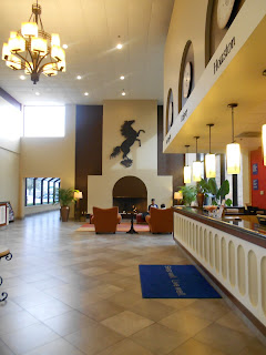 a lobby with a horse on the wall