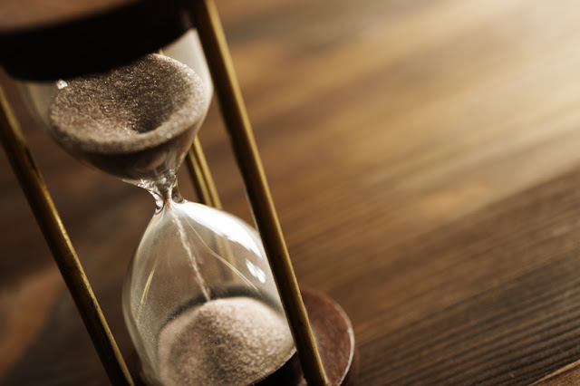 Sand running through an hourglass