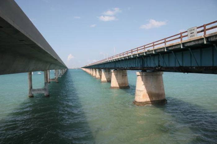 The Seven Mile Bridge is a famous bridge in the Florida Keys, in Monroe County, Florida, United States. It connects Knight's Key (part of the city of Marathon, Florida) in the Middle Keys to Little Duck Key in the Lower Keys. Among the longest bridges in existence when it was built, it is one of the many bridges on US 1 in the Keys, where the road is called the Overseas Highway.