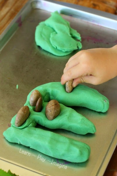 Making letters with playdough and rocks