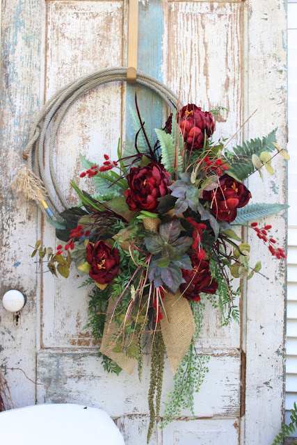red rope wreath with burlap bow 