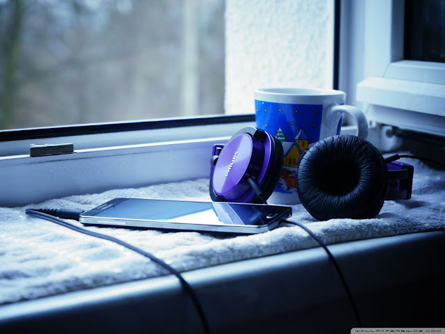 Headphone and smartphone along with a cup of tee