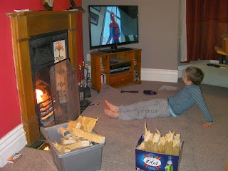 warming toes fireside with boxes of broken chopped wood